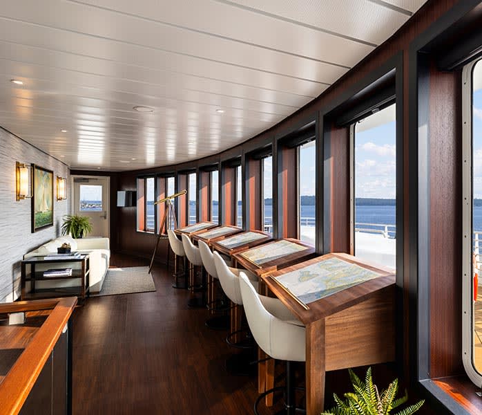 Luxury Cruise Ship Observation Lounge with Ocean Views An elegant observation lounge aboard a cruise ship featuring floor-to-ceiling windows overlooking
