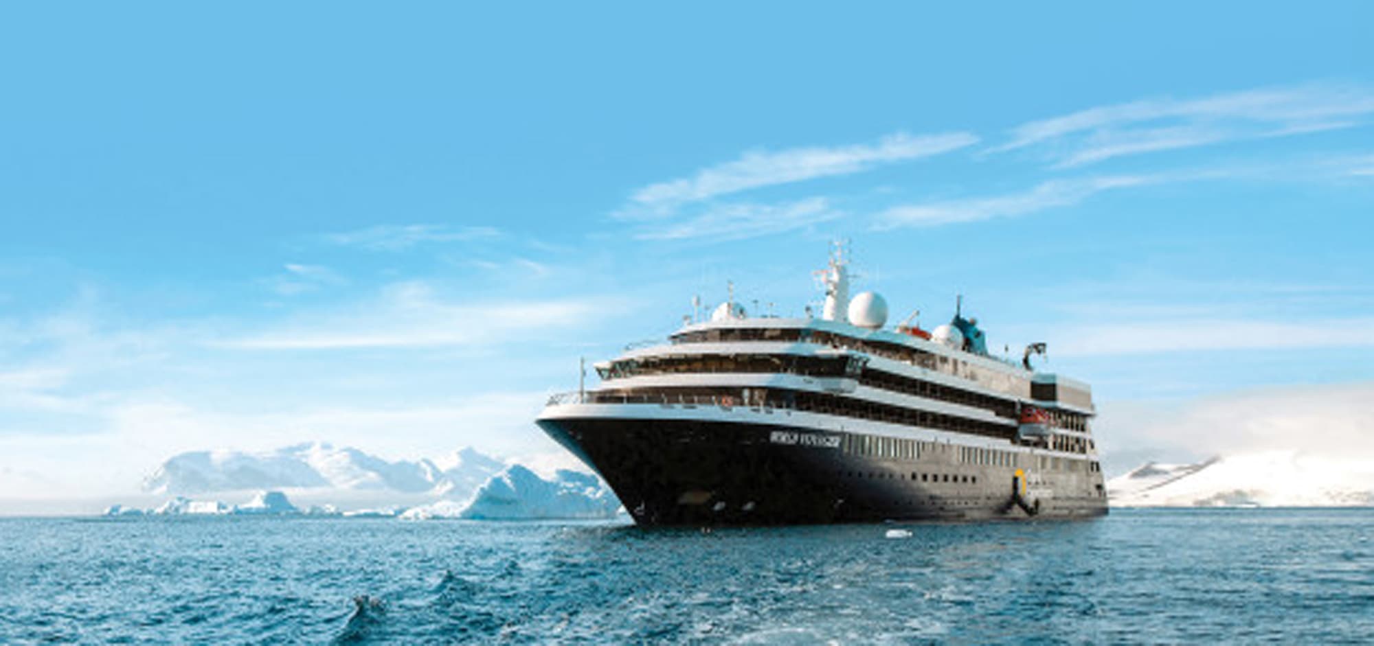 A sleek modern cruise ship navigating through icy blue waters with snow-covered mountains