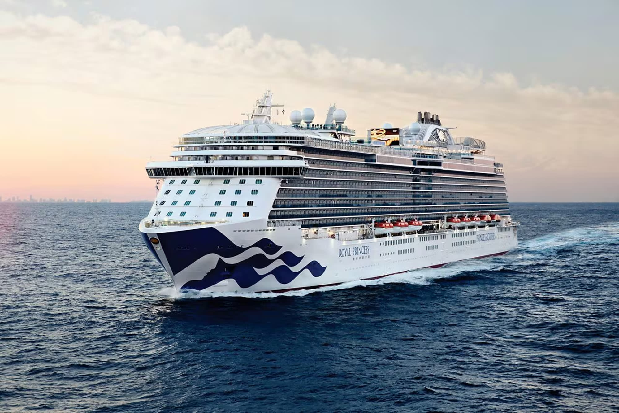 A large modern cruise ship from the Royal Princess fleet sailing on open water during