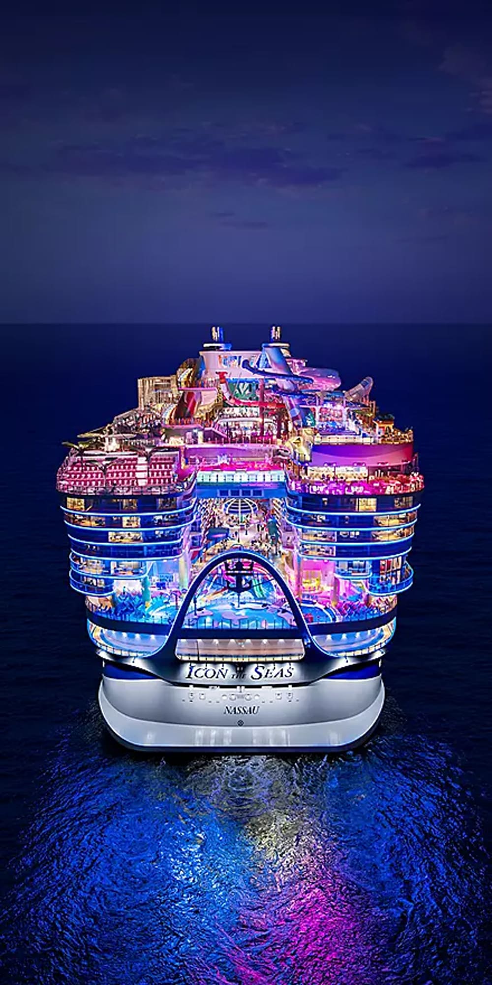 An aerial aft view of Royal Caribbean's Icon of the Seas cruise ship brilliantly illuminated