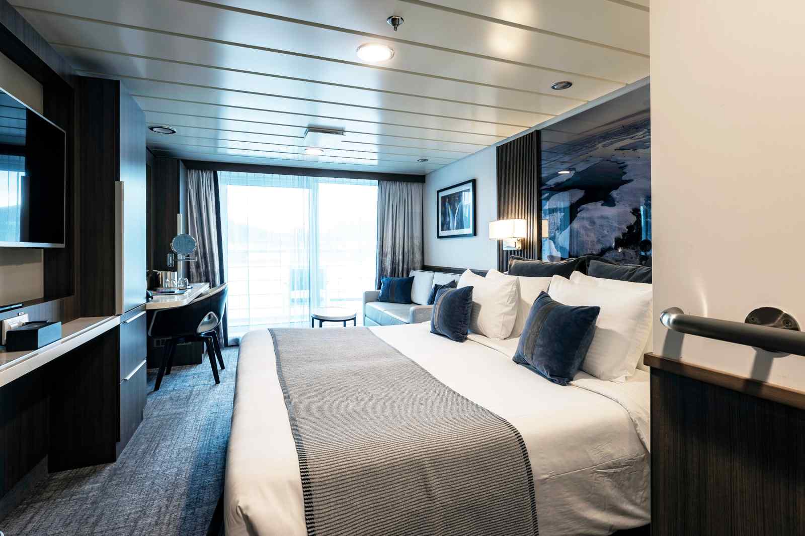 Luxury Cruise Ship Stateroom with Ocean View Luxury cruise ship stateroom with ocean view, featuring modern furnishings and comfortable bedding.