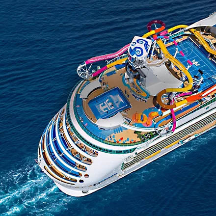 Navigator of the Seas Aerial Deck View An aerial view of a large cruise ship featuring colorful waterslides, multiple deck levels