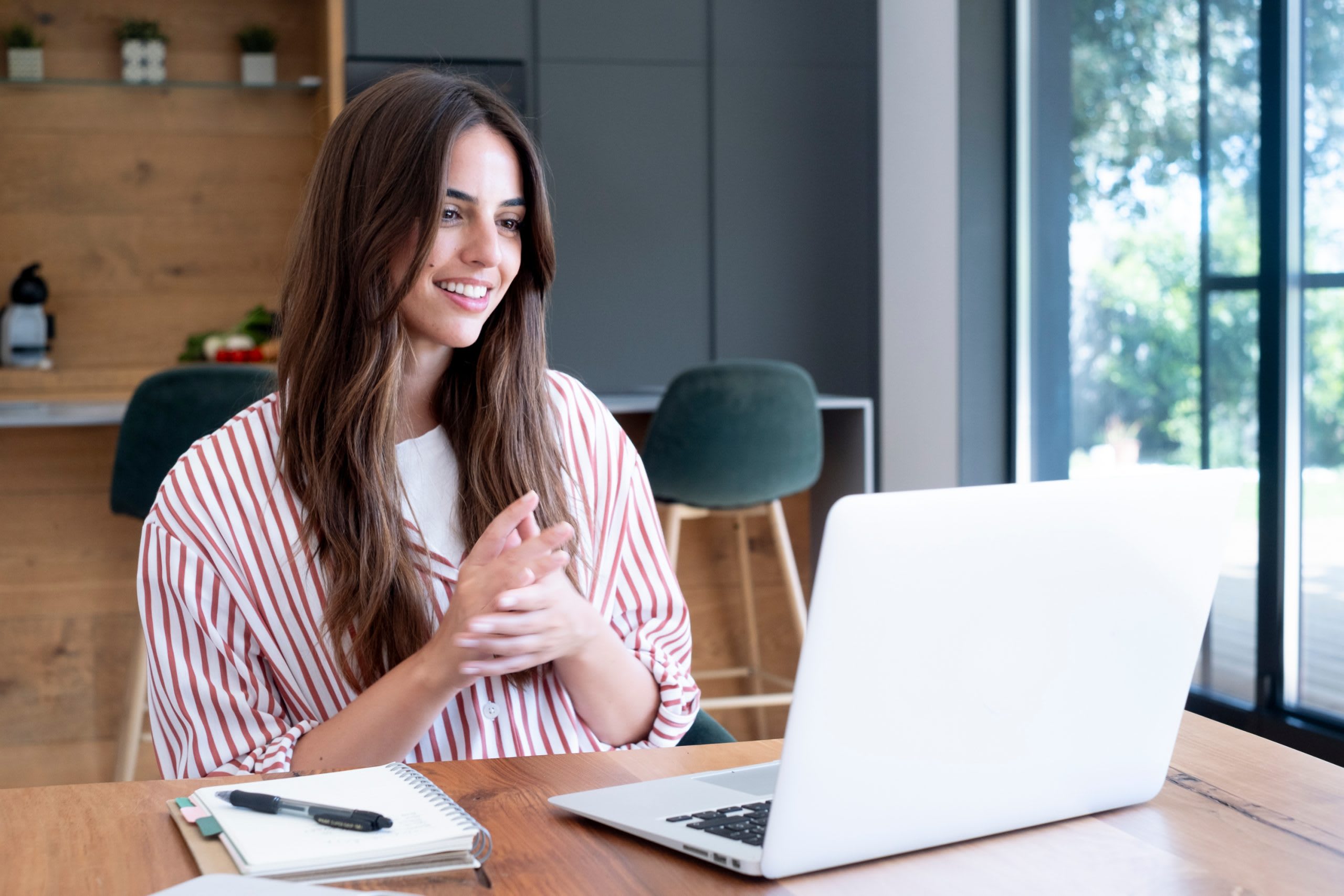 Happy travel agent on a video call with a client