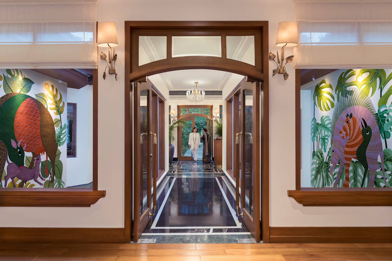 Dining_Restaurant Entrance Upscale restaurant entrance with wooden doors, tropical artwork murals, and elegant lighting