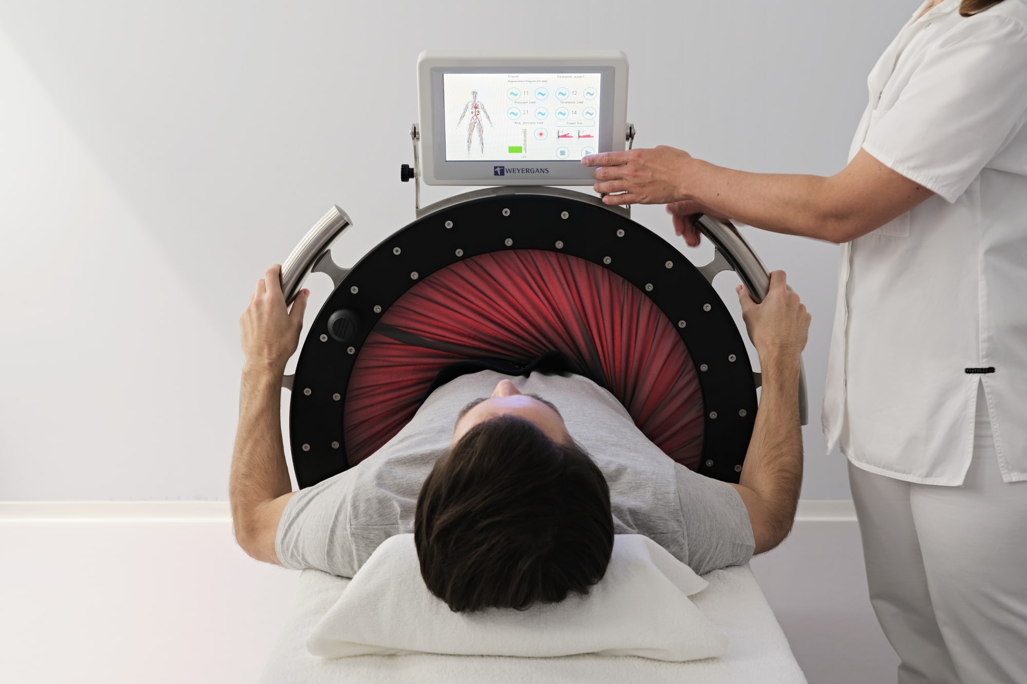 GGArchard_Chenot_2024-10_24 Patient undergoing bioimpedance analysis scan with technician monitoring digital display showing body composition data