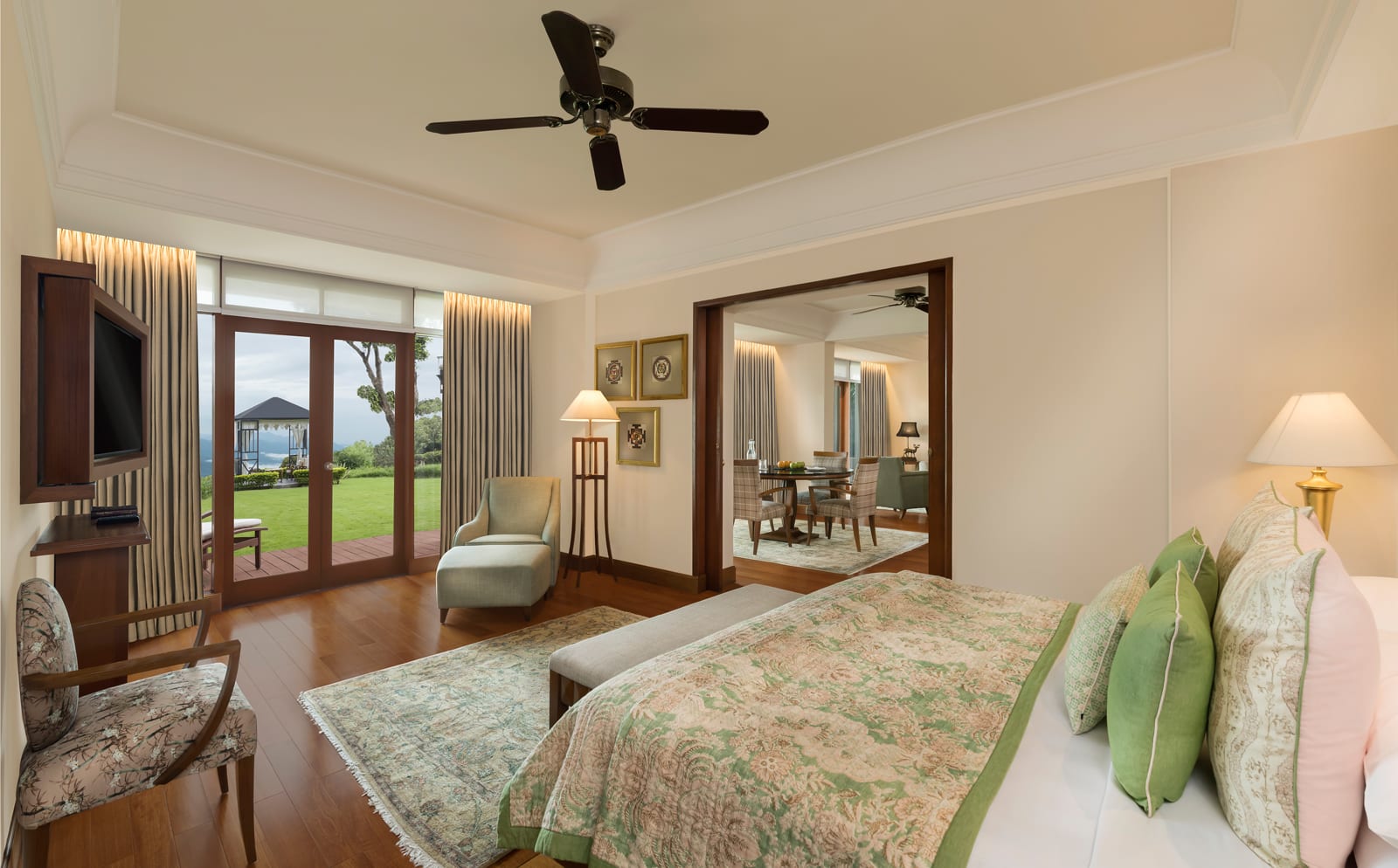 Living_Ananda Suite bedroom Luxury resort bedroom with wood-frame doors overlooking manicured lawn and mountain view
