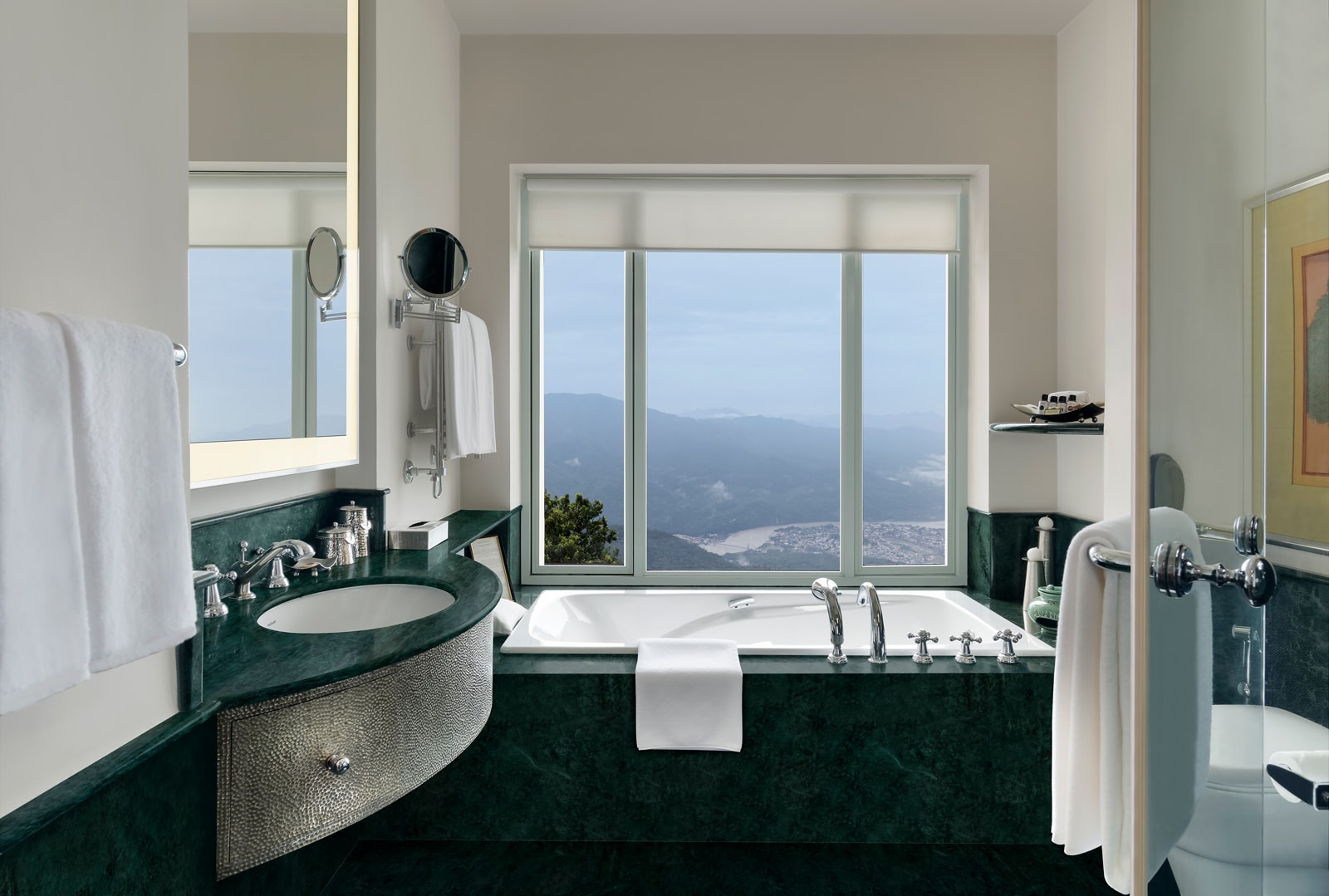 Living_Deluxe room bath Luxury bathroom with dark green marble, soaking tub, and expansive mountain valley views through floor-to-ceiling windows