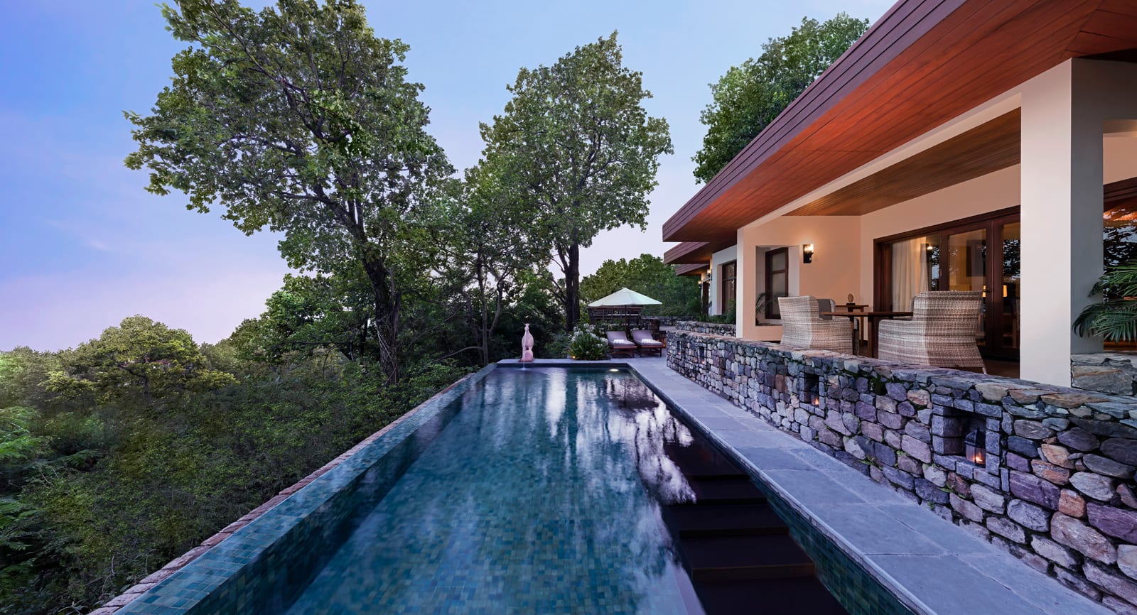 Living_Villa Two Bedroom pool Modern villa with infinity pool overlooking forested landscape at dusk