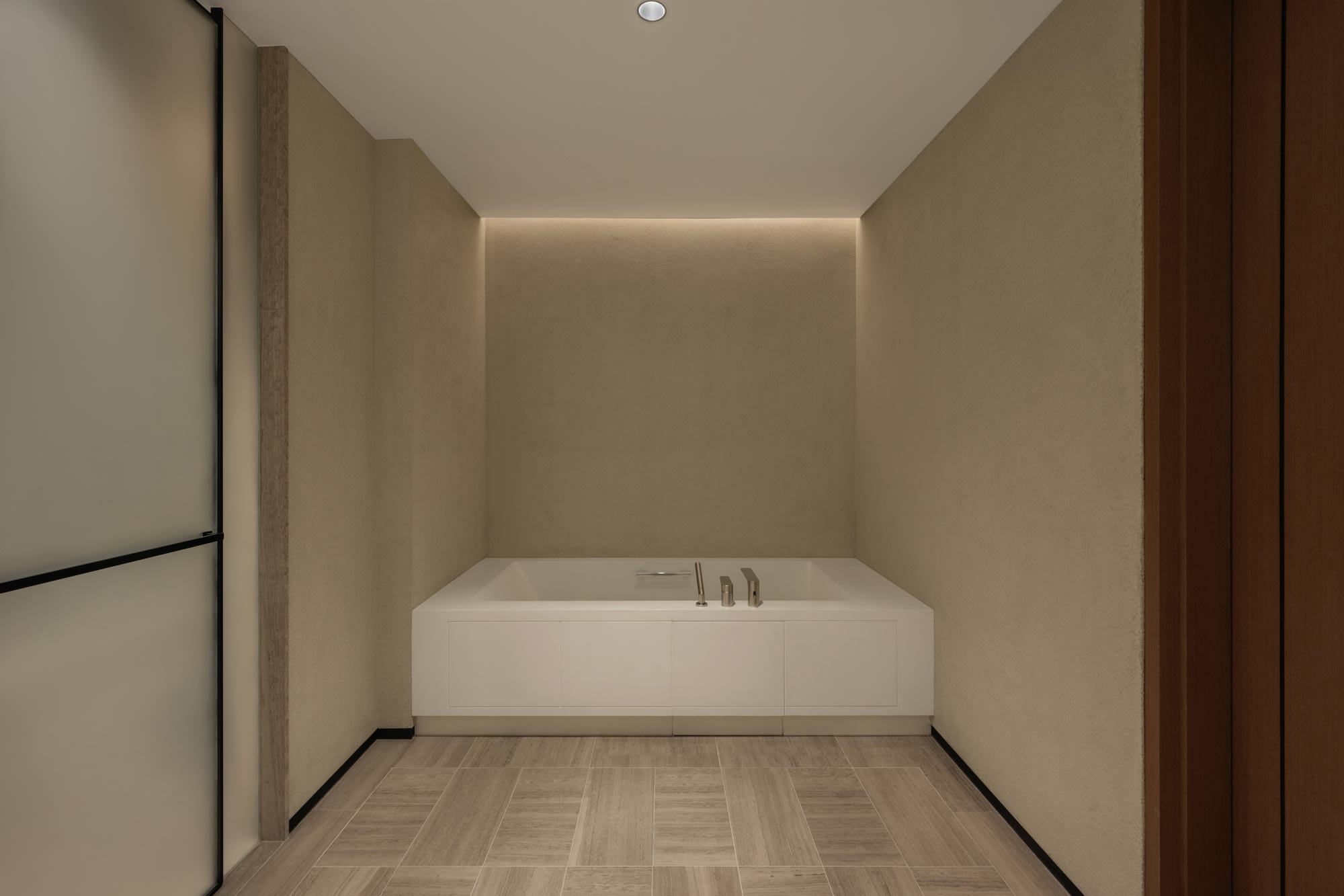 Siro Hotels Dubai Modern bathroom with white freestanding soaking tub and ambient lighting