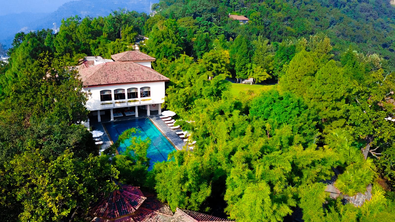 Wellness_Spa pool 1 Luxury spa resort with turquoise infinity pool nestled in lush green forest and mountains