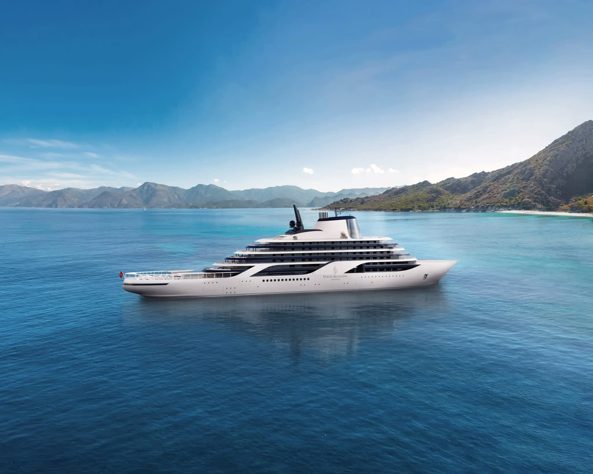 Four Seasons I luxury yacht anchored in a scenic mountain bay with turquoise waters