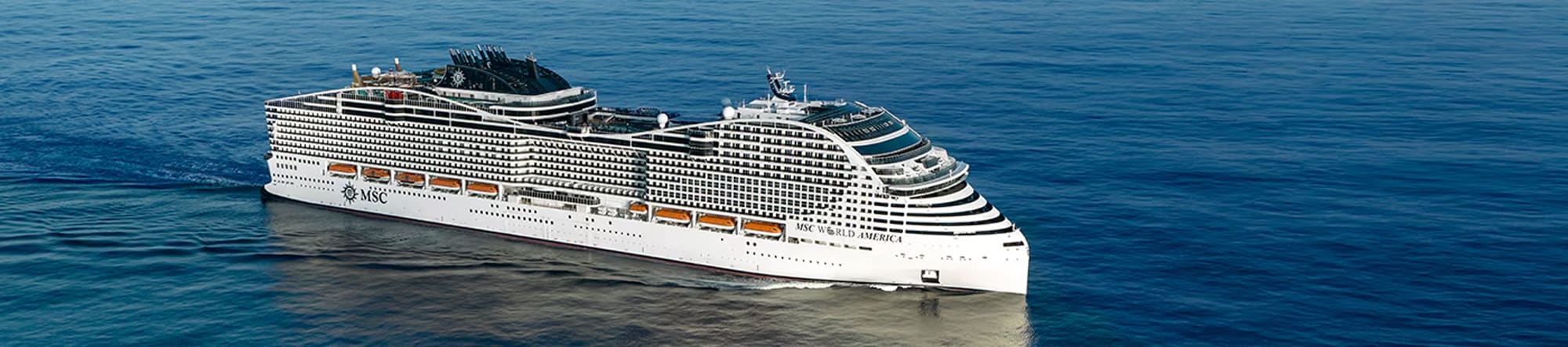 MSC World America Cruise Ship at Sea A large, modern MSC cruise ship sailing on calm blue waters, showcasing its sleek white design