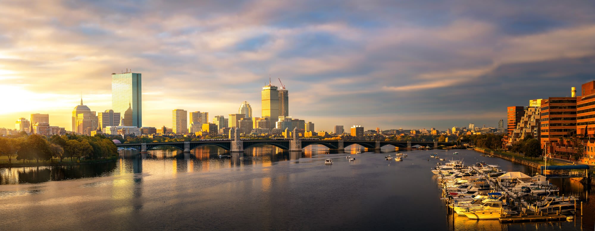 Boston skyline across the water at sunset