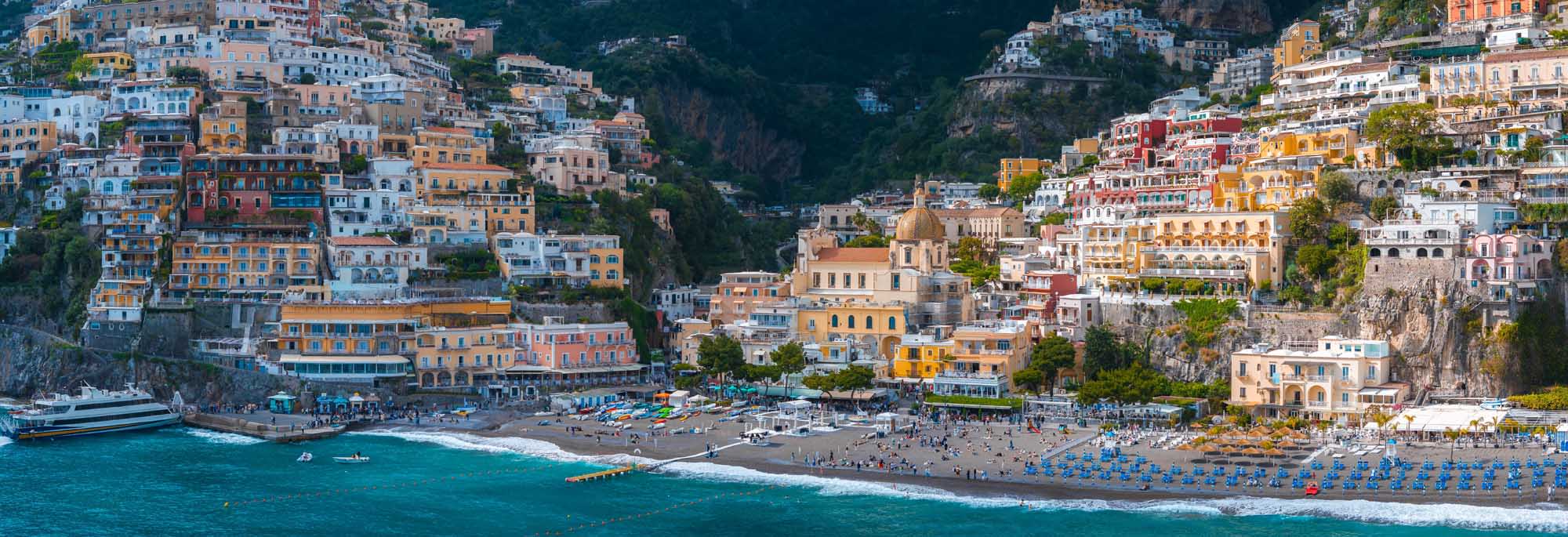 A stunning aerial view of Positano, Italy, showcasing vibrant pastel-colored buildings cascading