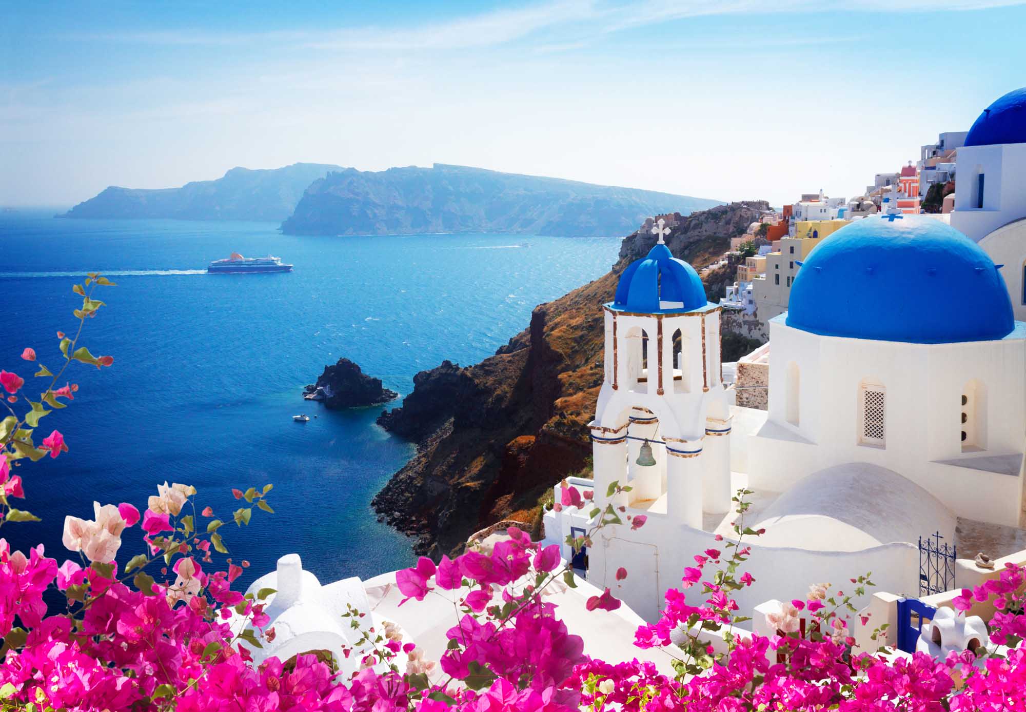 A picturesque view of Oia village in Santorini, Greece, featuring iconic white-washed buildings