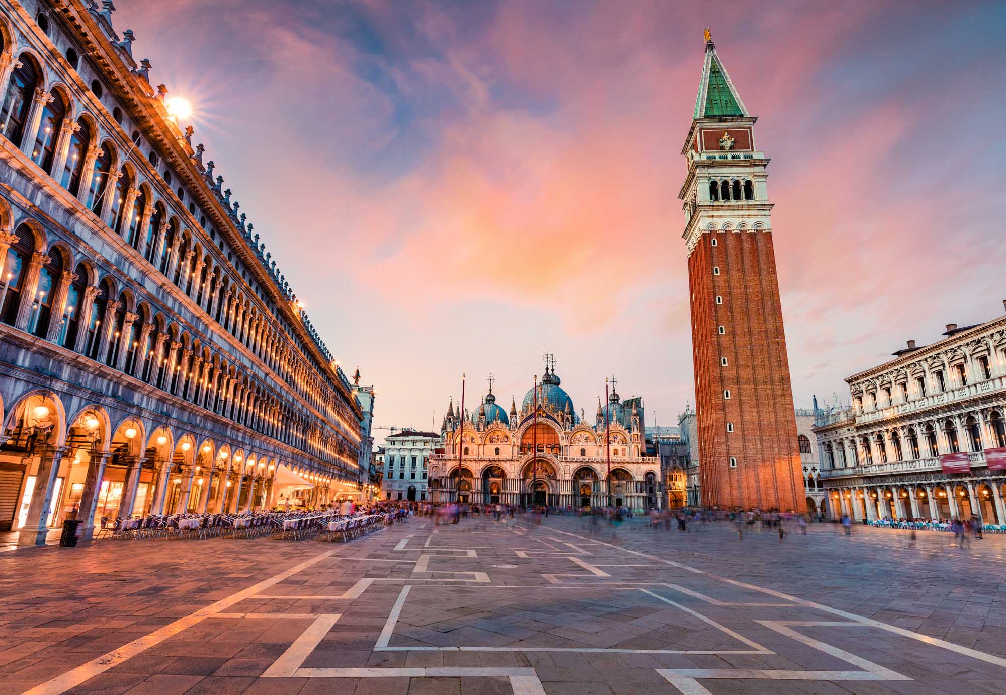 A stunning twilight view of Venice's iconic St. Mark's Square (Piazza San Marco) featuring