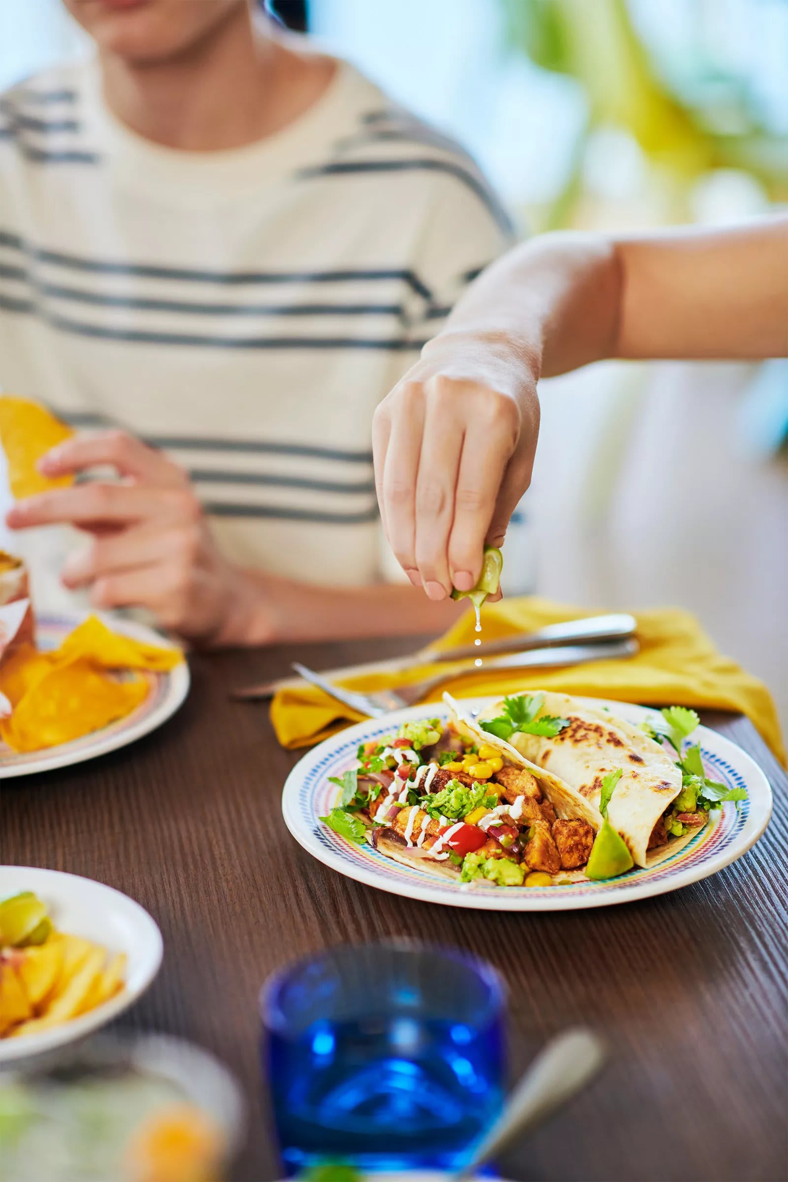 Guest squeezing lime on a soft taco at El Loco Fresh