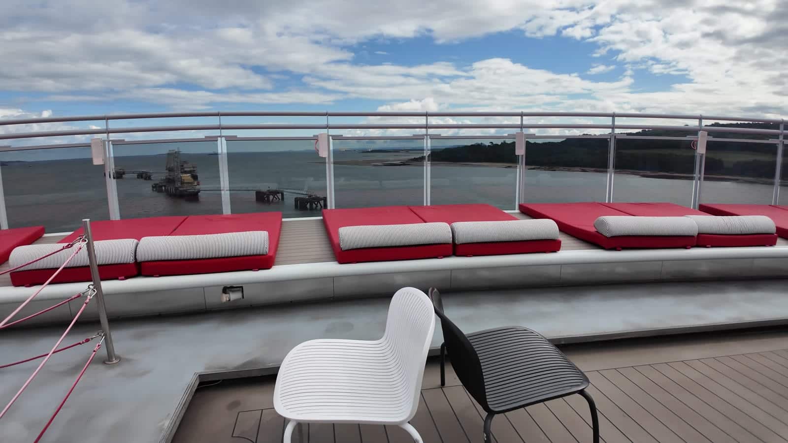 New shaded daybed clusters under red umbrellas at the Athletic Club on Valiant Lady