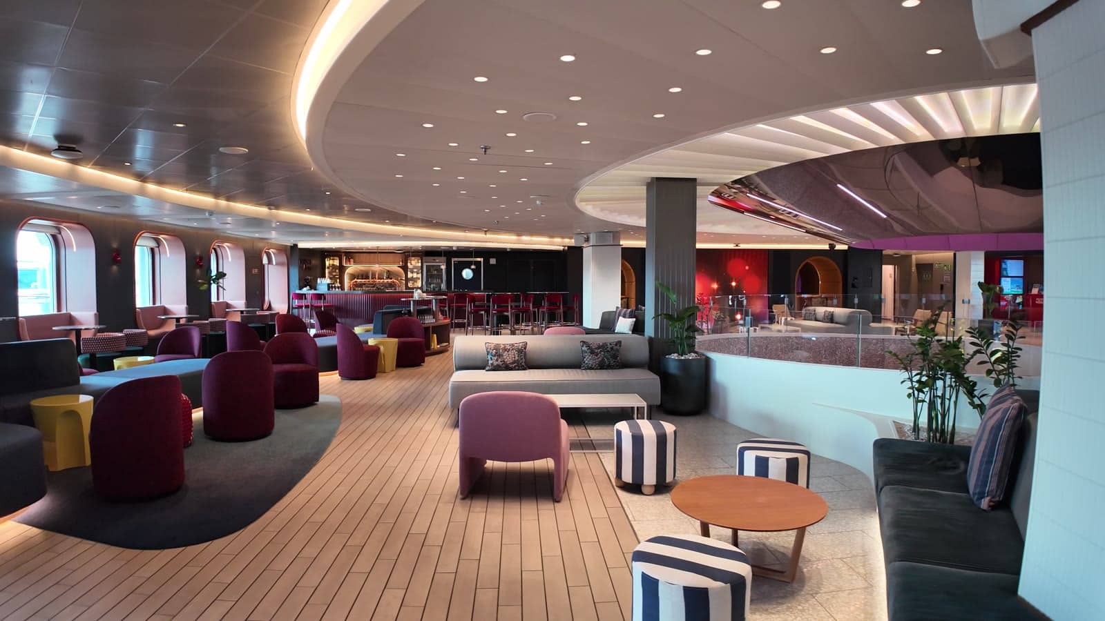 Plum lounge seating near The Roundabout on Valiant Lady after the 2026 dry dock