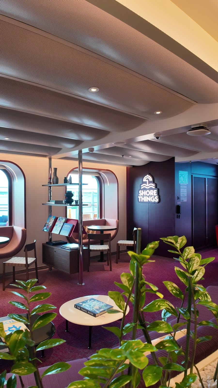 New Shore Things hub with seating and destination books on Valiant Lady