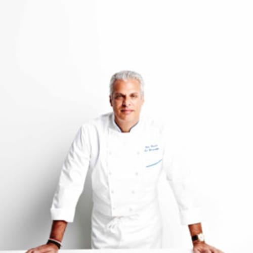 a photo of a man with white hair in a chef's coat