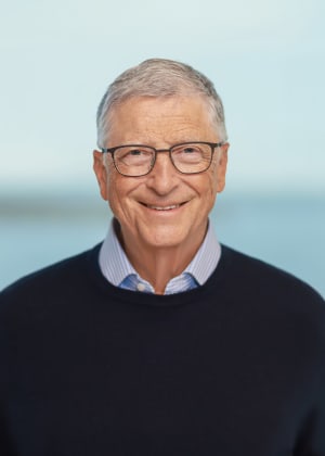 photo of a white man with gray hair and glasses wearing a black sweater