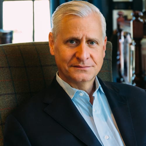 Photo of author Jon Meacham sitting in a chair