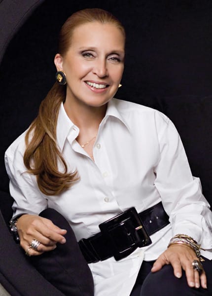 Danielle Steel wearing a white button down shirt in front of a black background