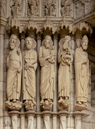 Gently elongated prophetic figures — from the left, Isaiah, Jeremiah, Simeon, John the Baptist, and Simon Peter — from the north portal of Chartres Cathedral.
