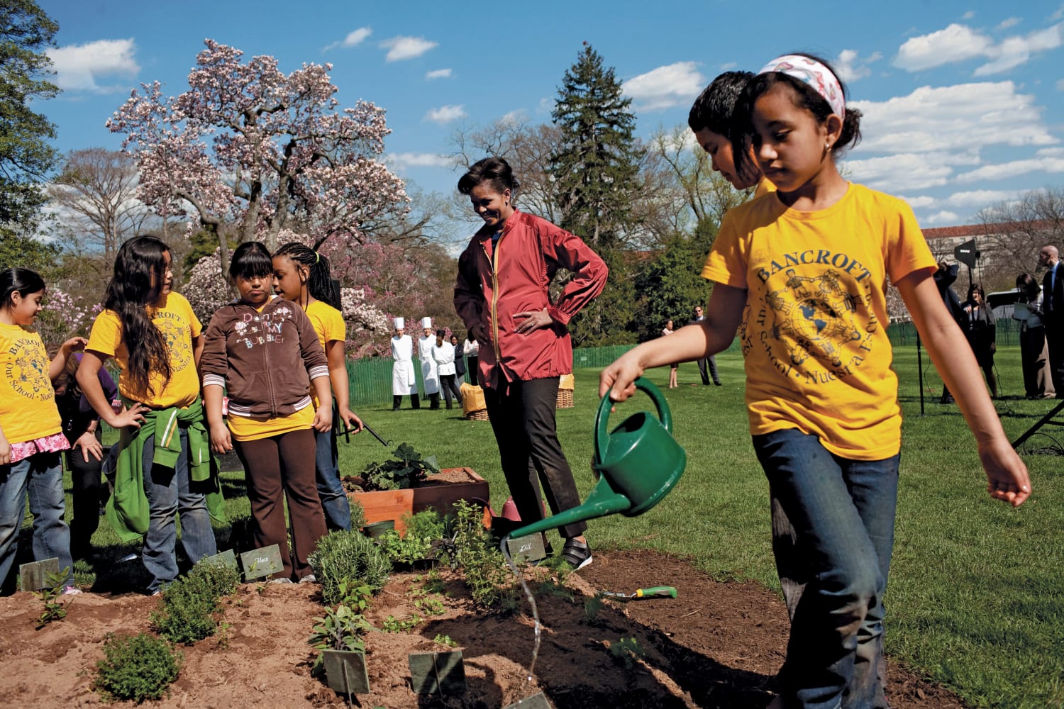 Michelle Obama working in the White House Garden with children