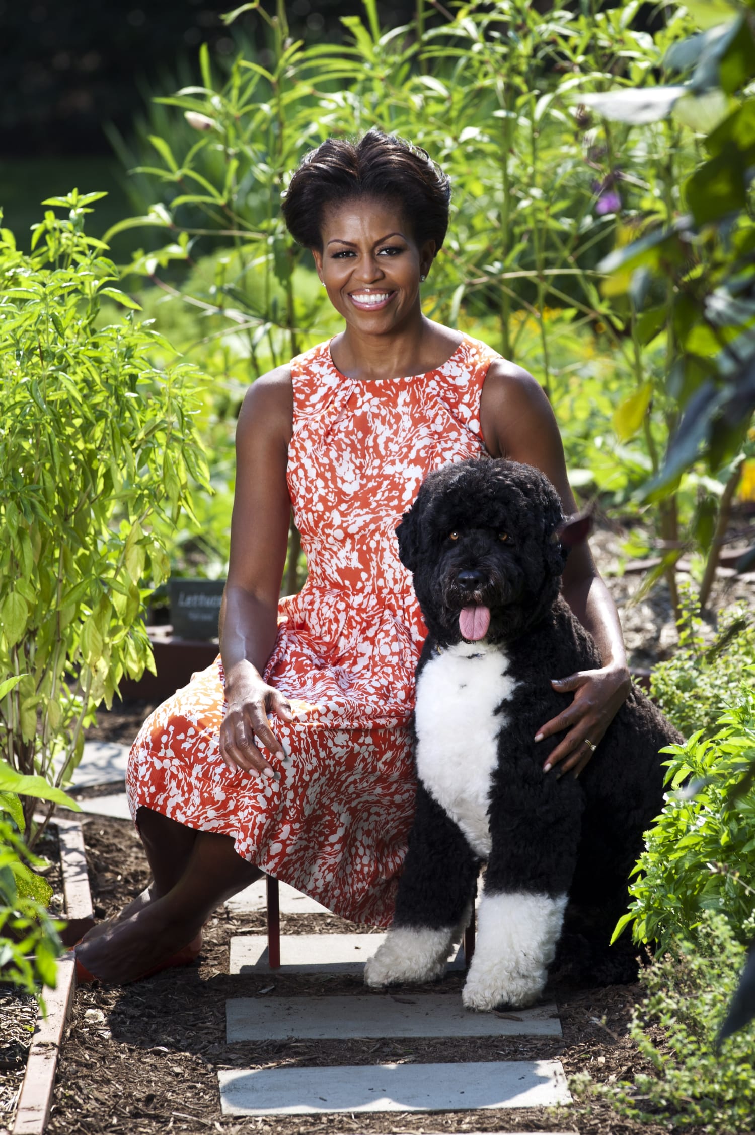 A photo of Michelle Obama and her dog in the White House Garden