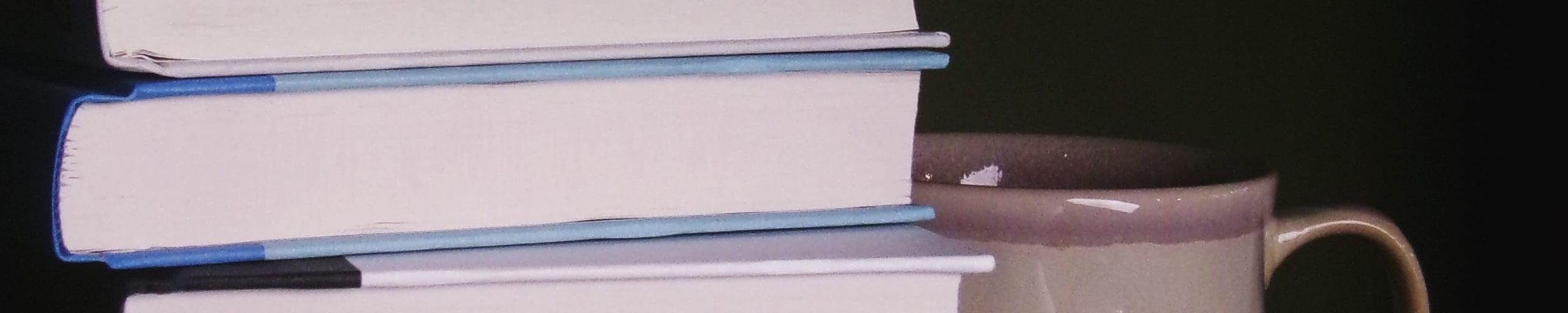 Stack of books and a mug