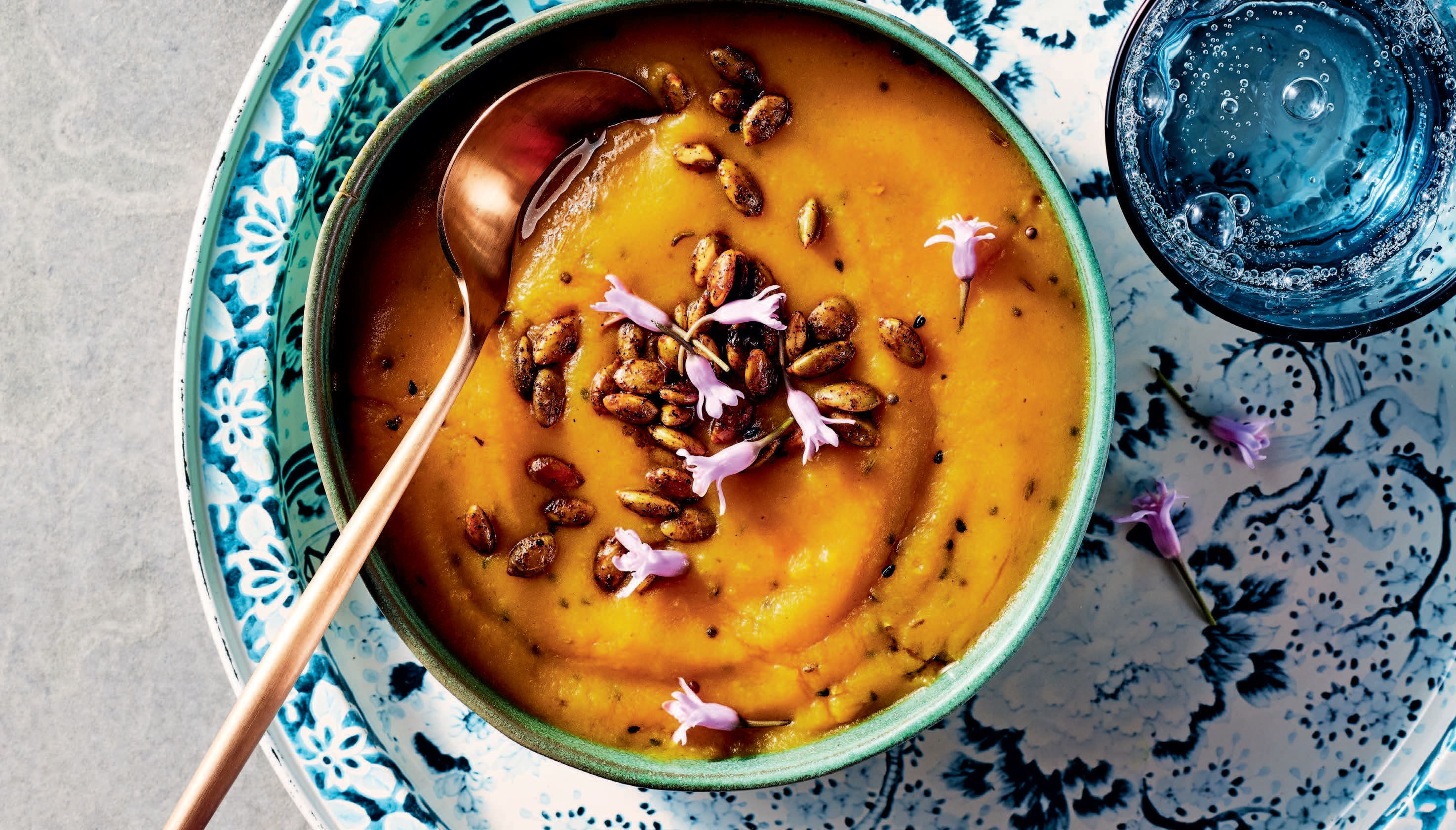 golden orange soup in blue bowl