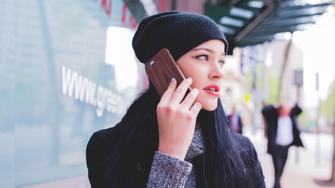 Woman talking on the phone, looking skeptical