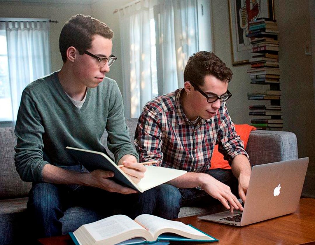 Two high school age students studying at their home