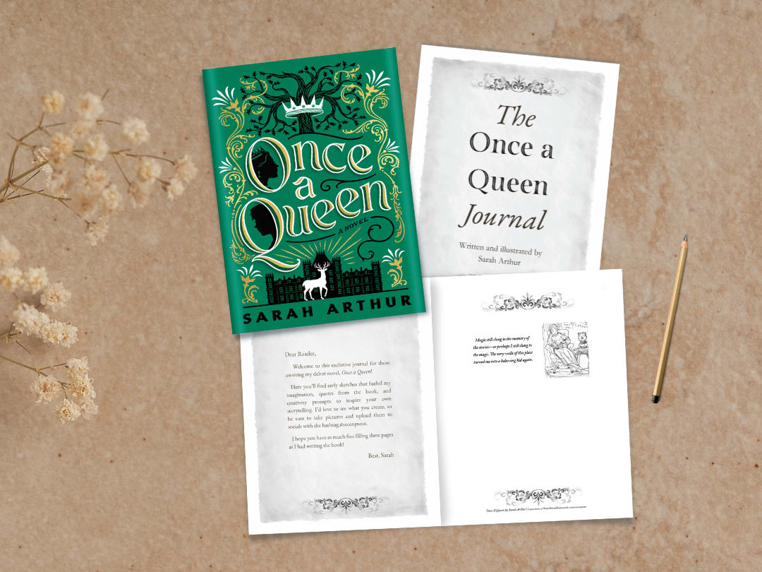 A photo of the book with the exclusive Once a Queen Journal on a desk