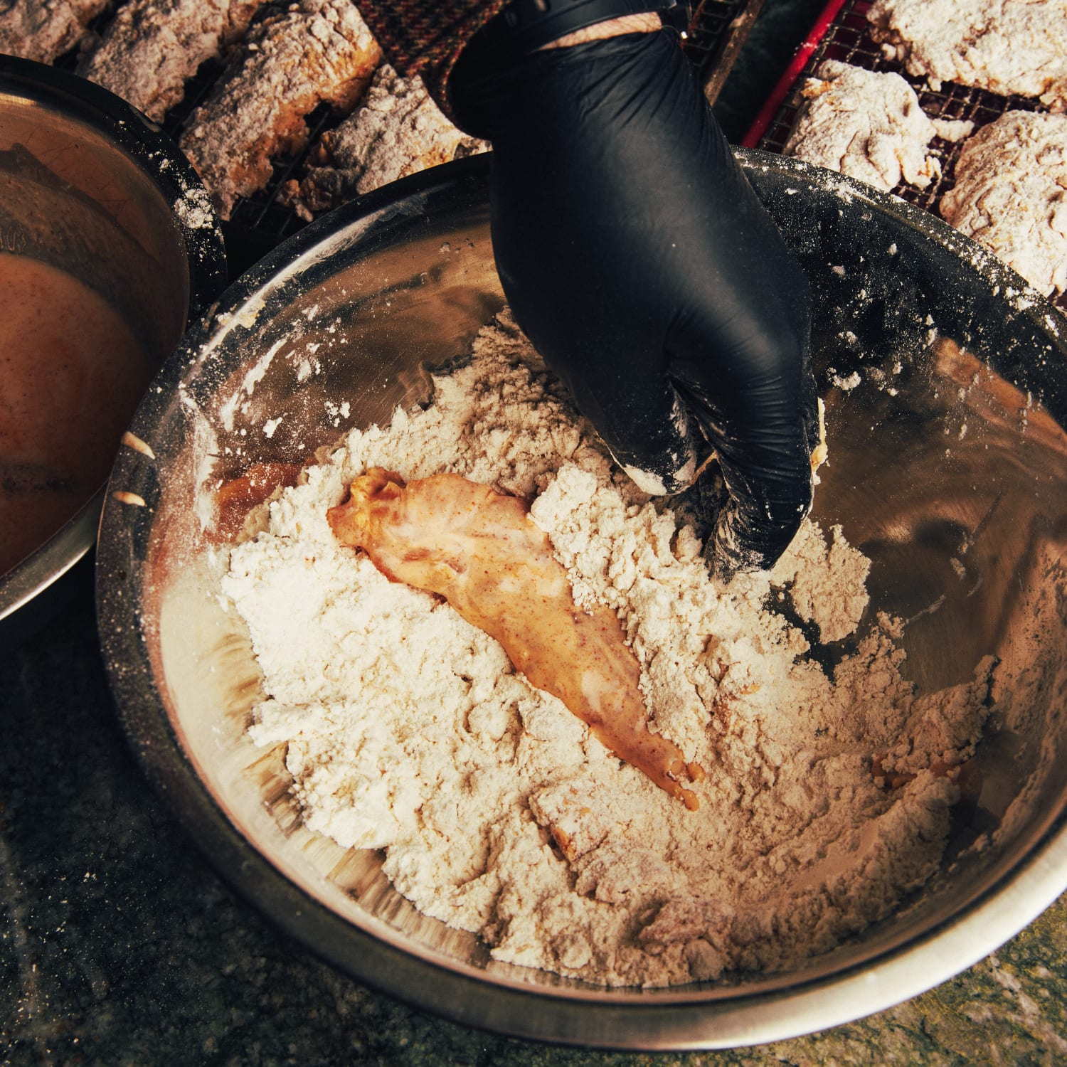 Sauced chicken being floured