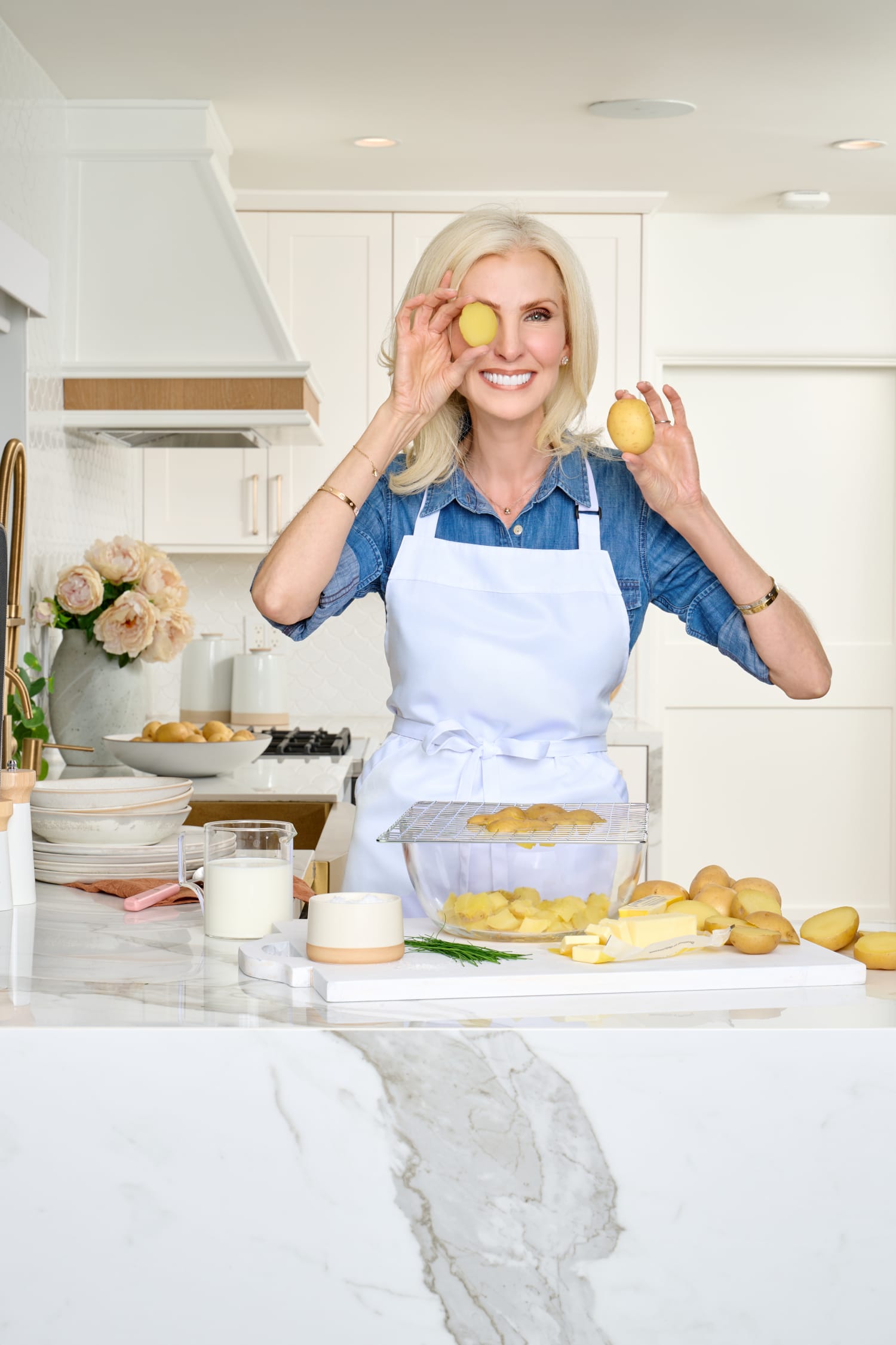 Lora of Lorafied in her kitchen holding up cupcakes