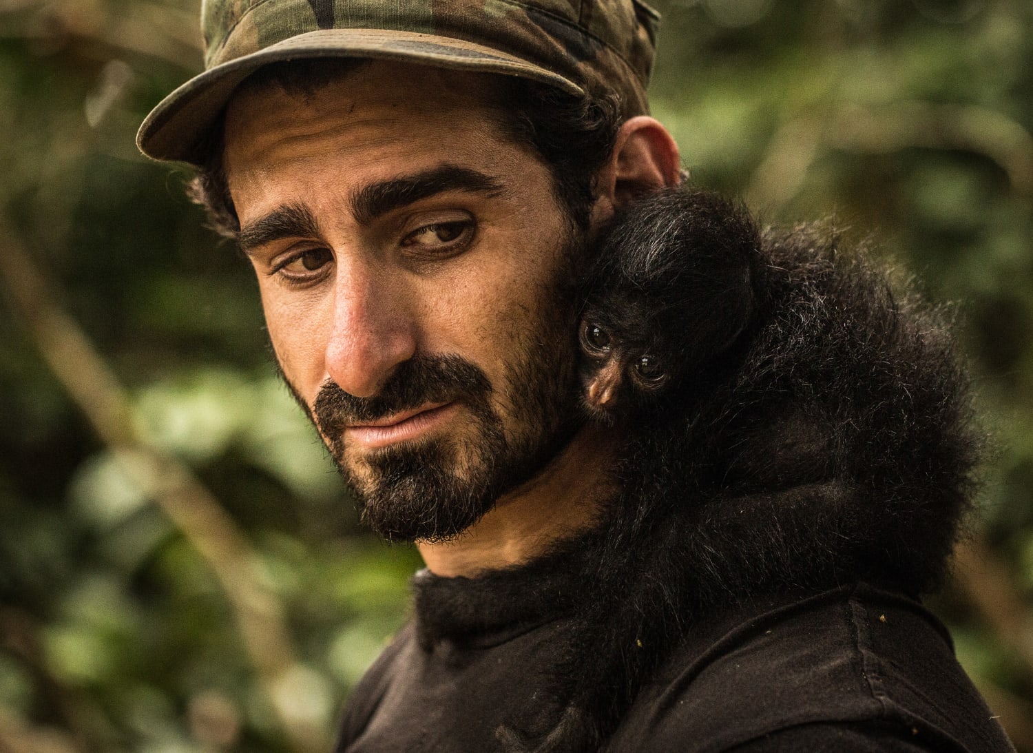 Paul Rosolie with a small monkey on his shoulder