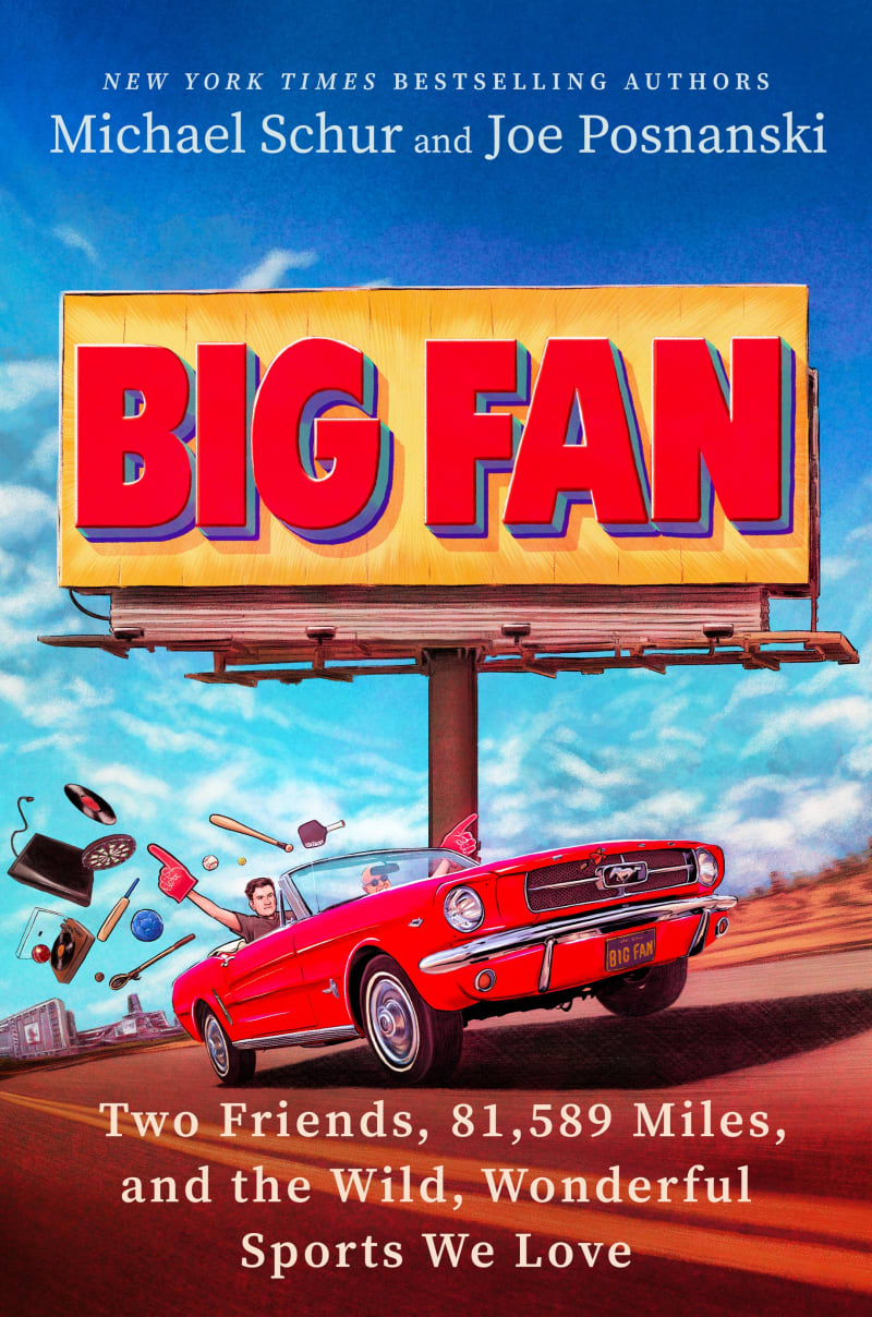 An illustrated image of authors Mike Schur and Joe Posnanski driving in a vintage-style convertible car, with sports and fan memorabilia streaming out behind them, underneath a large BIG FAN billboard.
