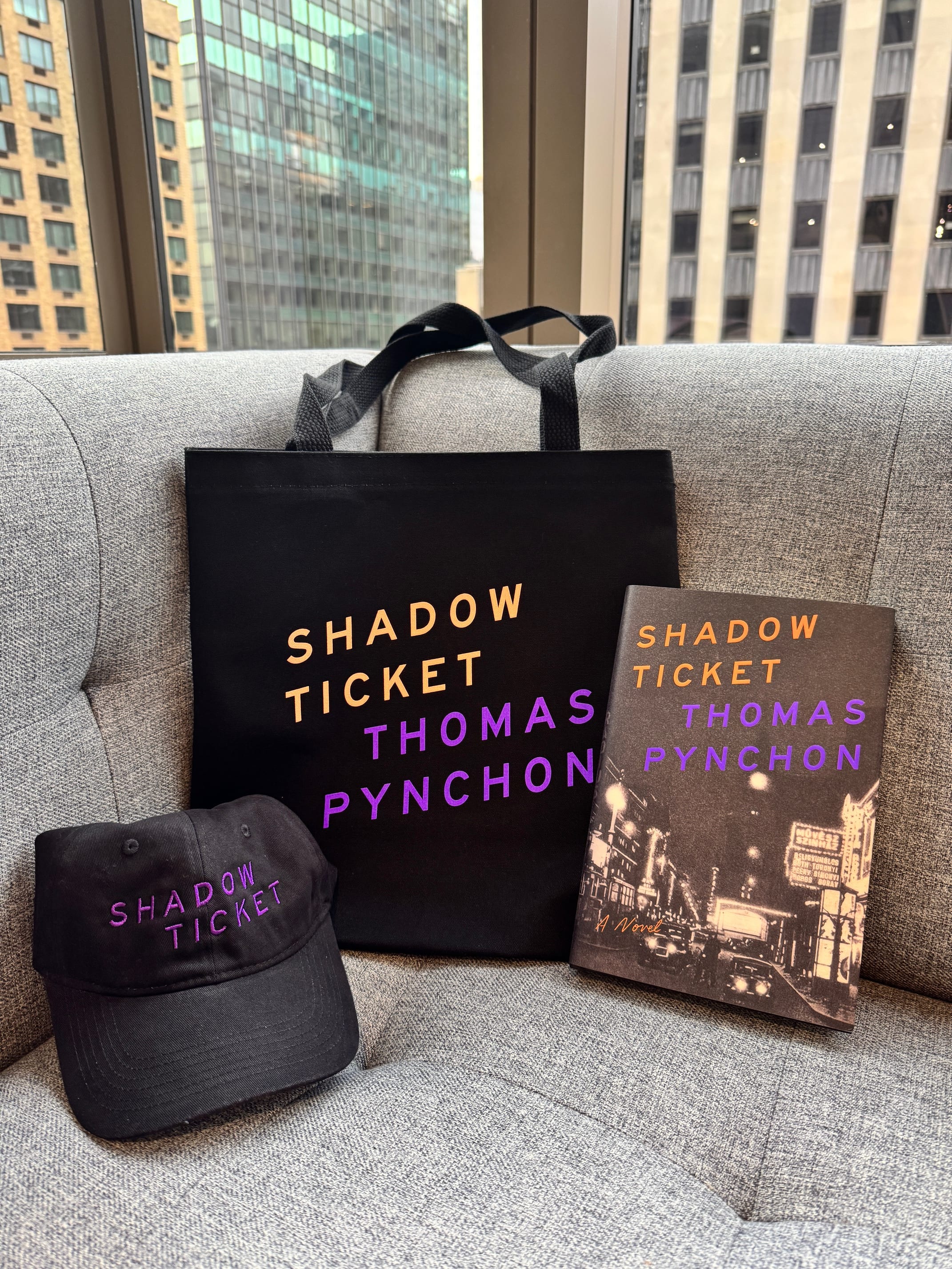 Image of Shadow ticket hat, tote bag, and book