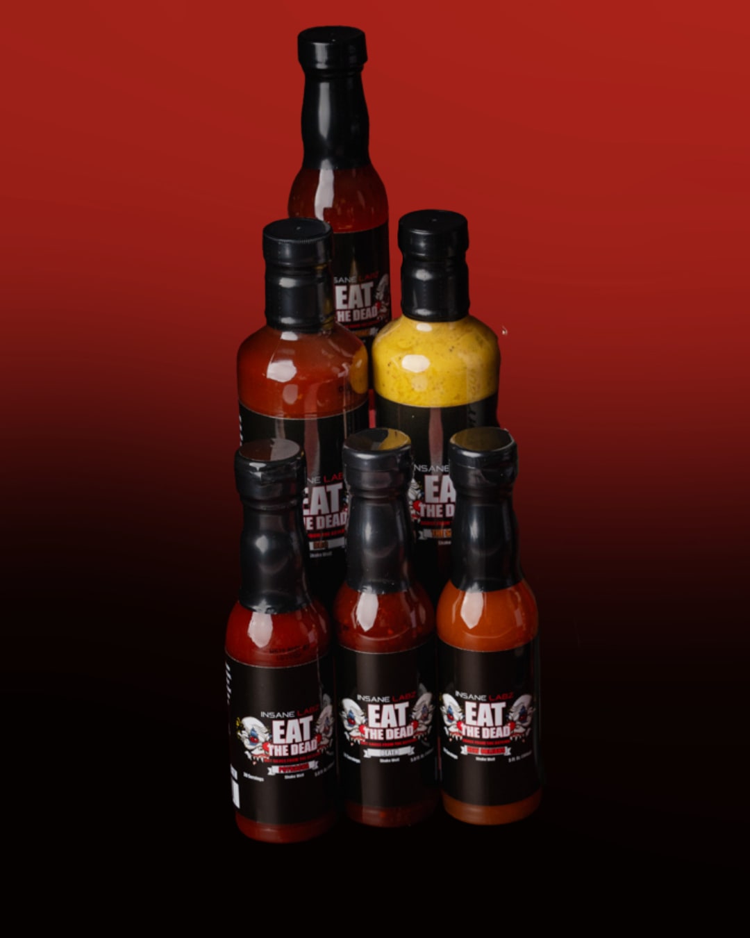 6 bottles of hot sauce stacked on top of each other in front of a red and black background
