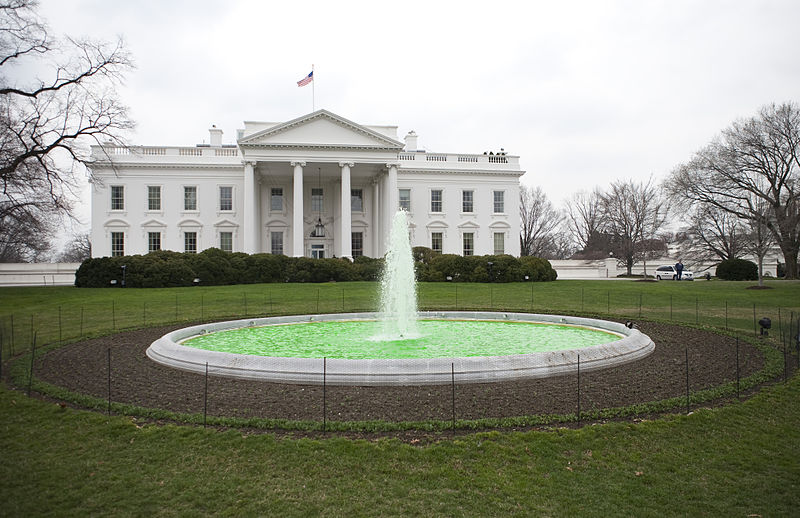 White house with green water fountain