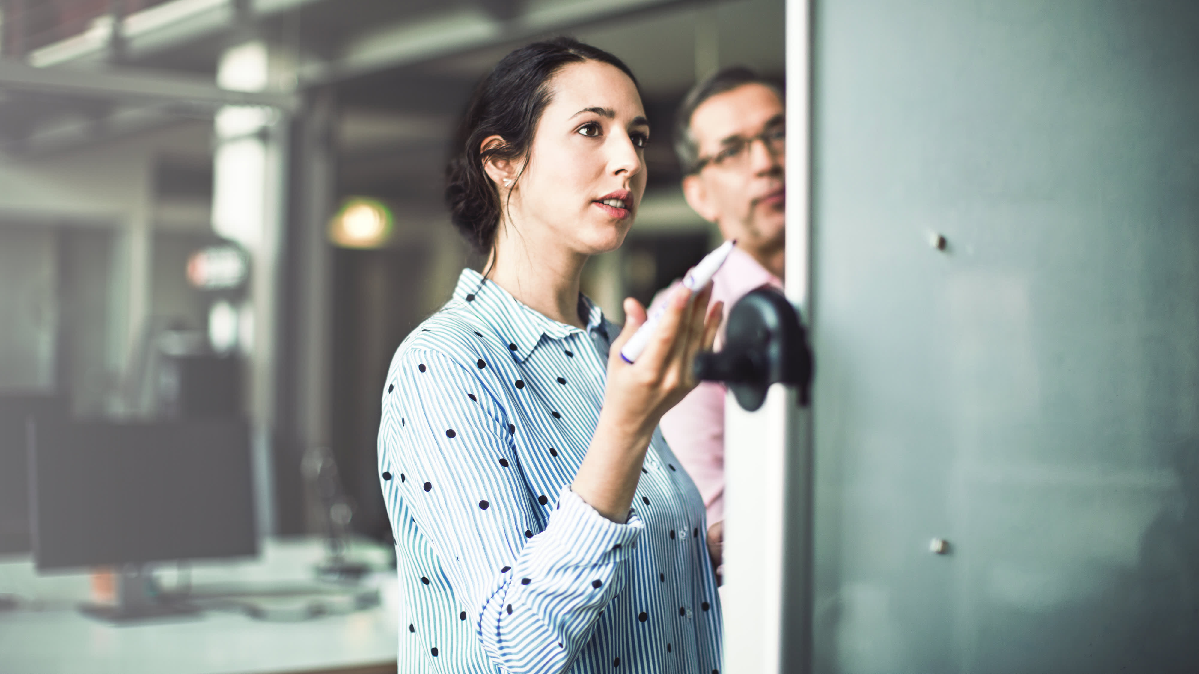 Businesswoman looking at whiteboard during meeting