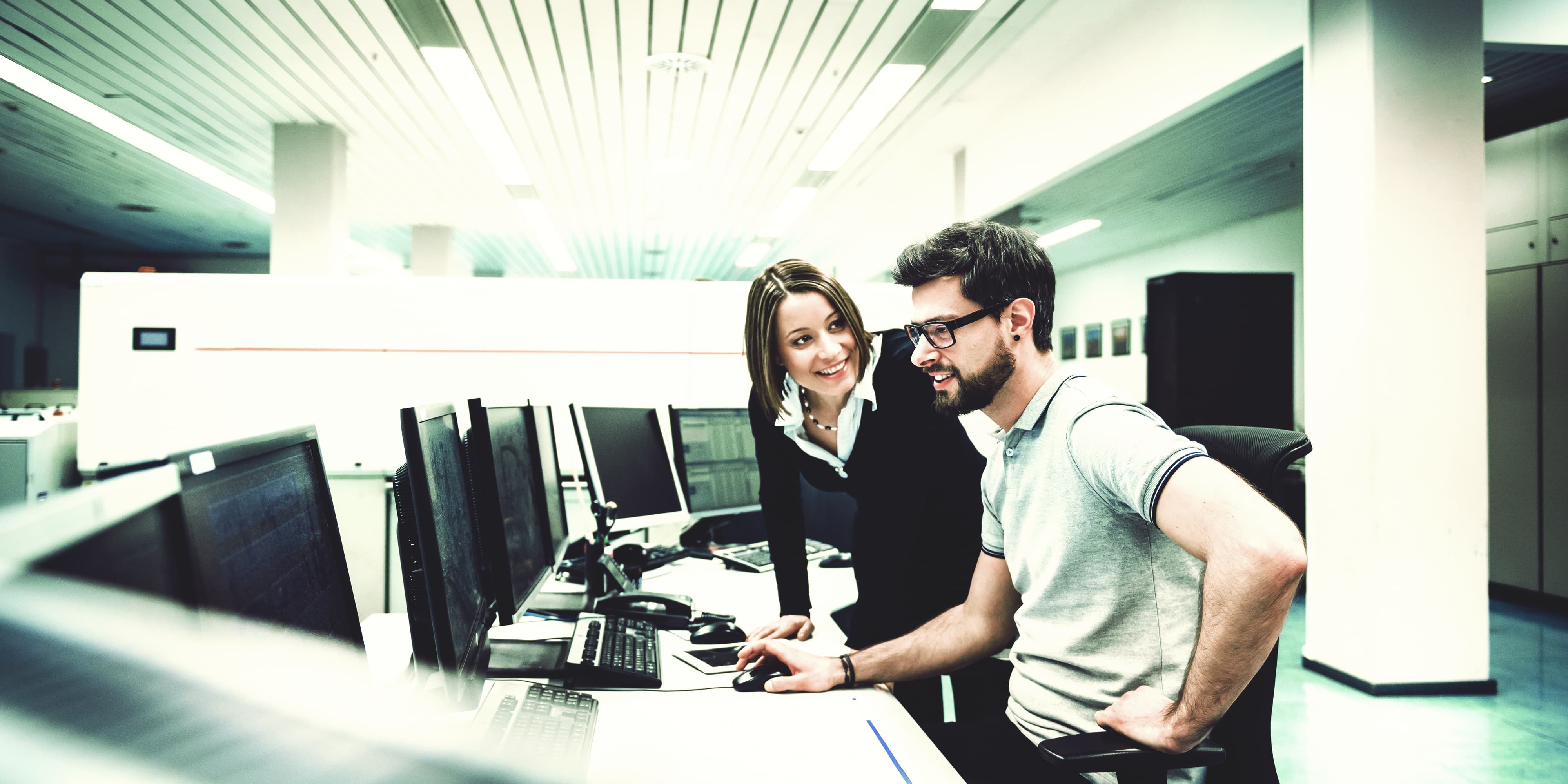 Mann und Frau arbeiten gemeinsam an Desktop