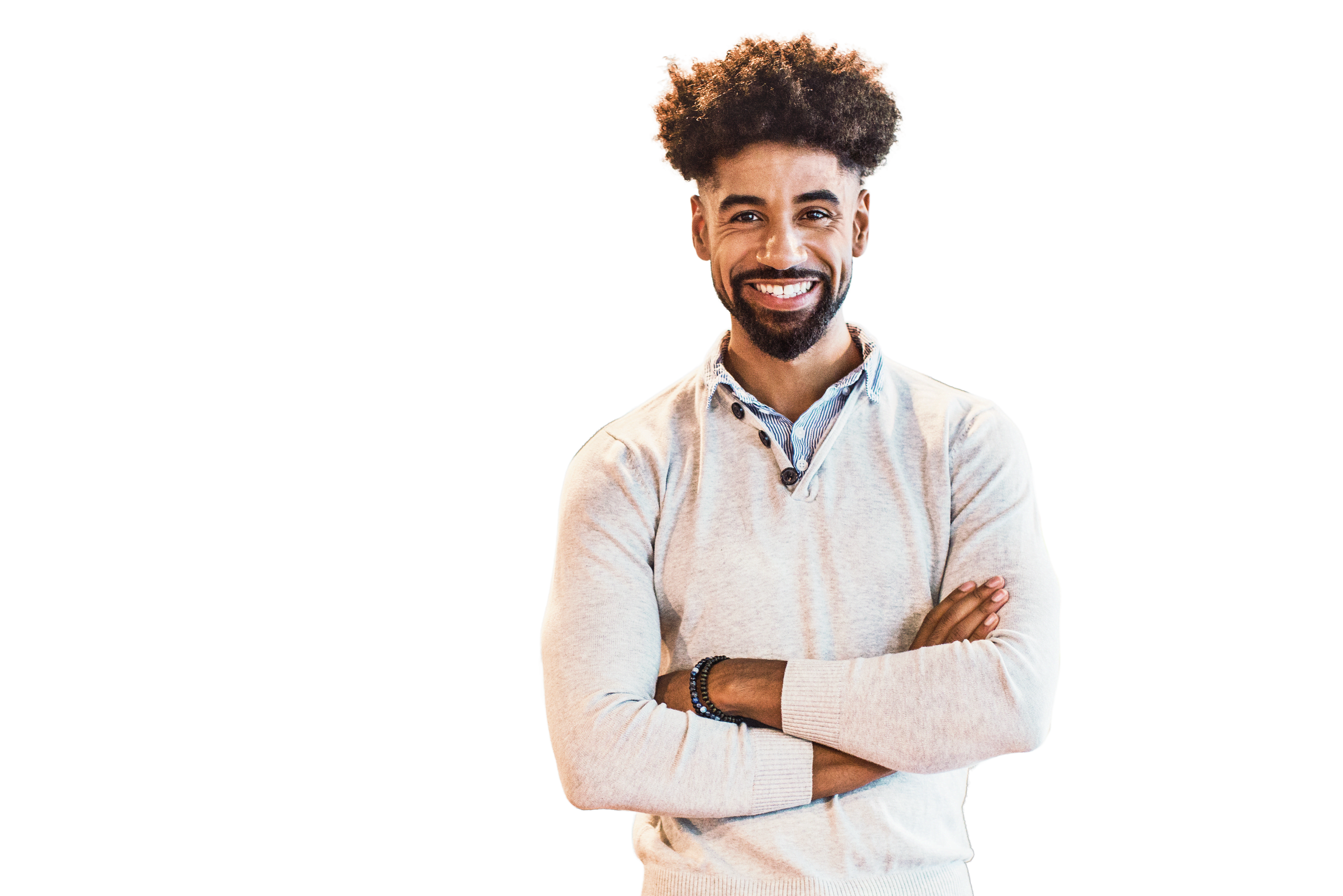 Smiling young businessman standing arms crossed in office
