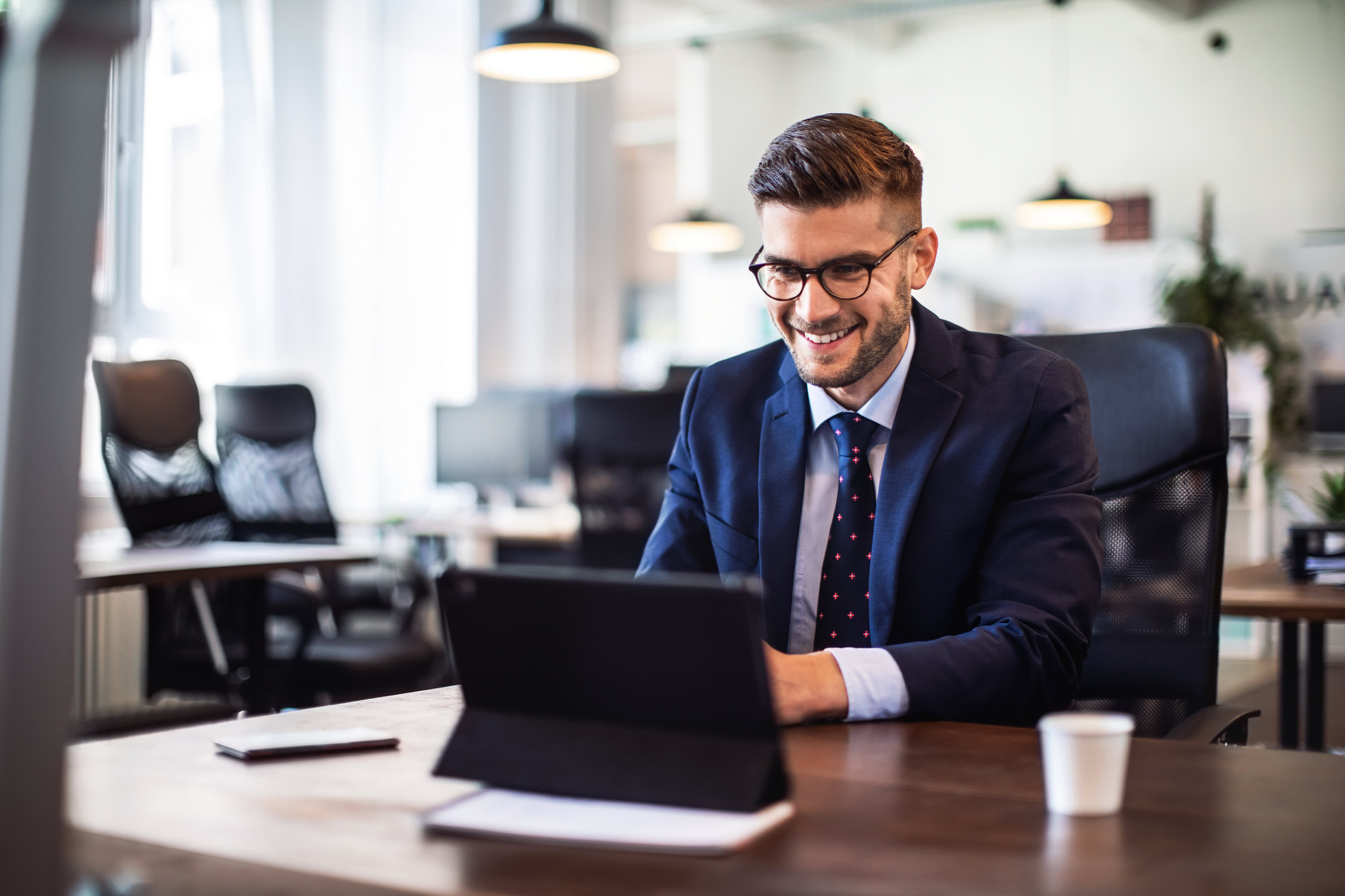 Businessman having online briefing with team at office
