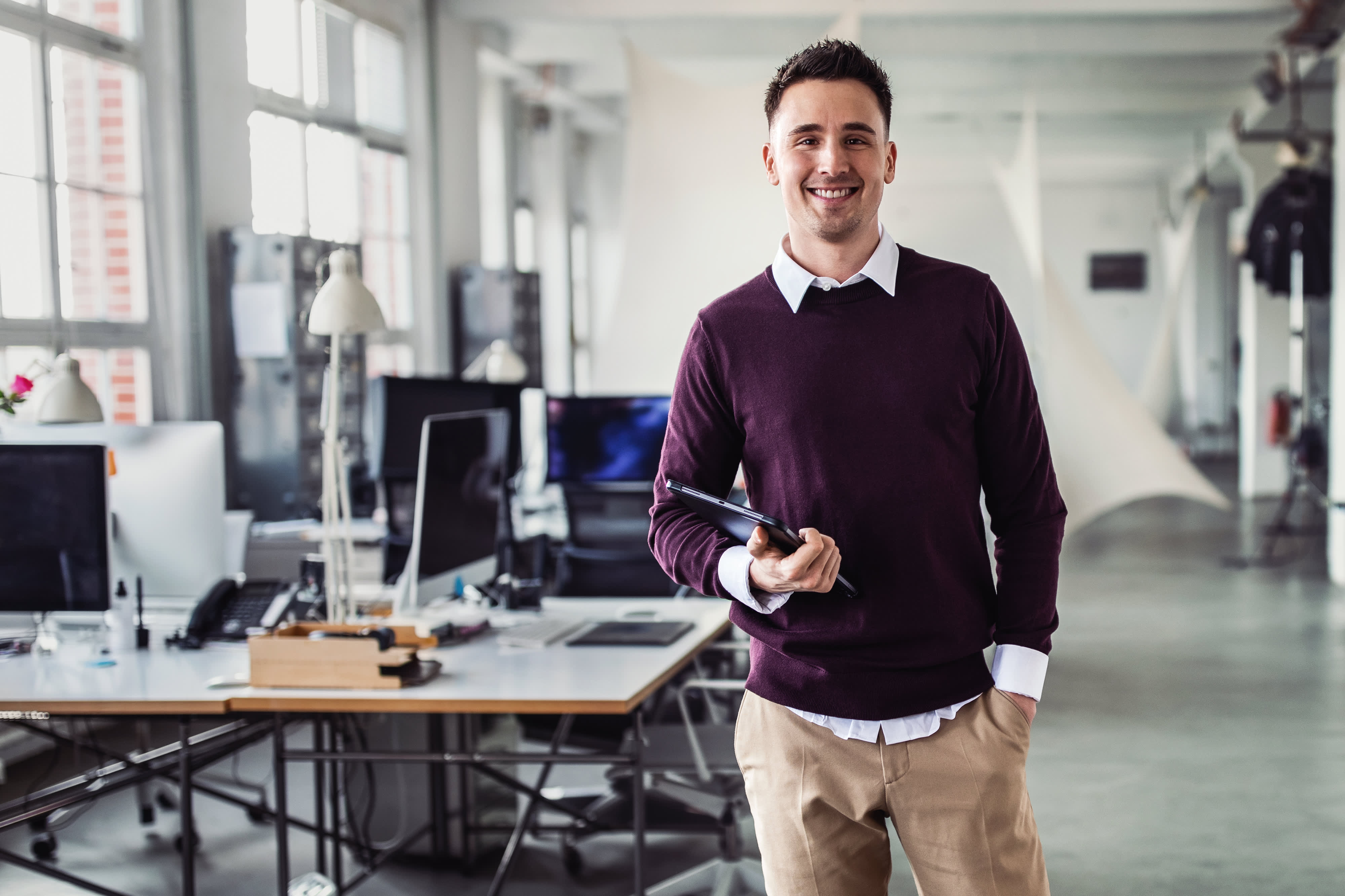 Portrait of a young businessman with digital tablet