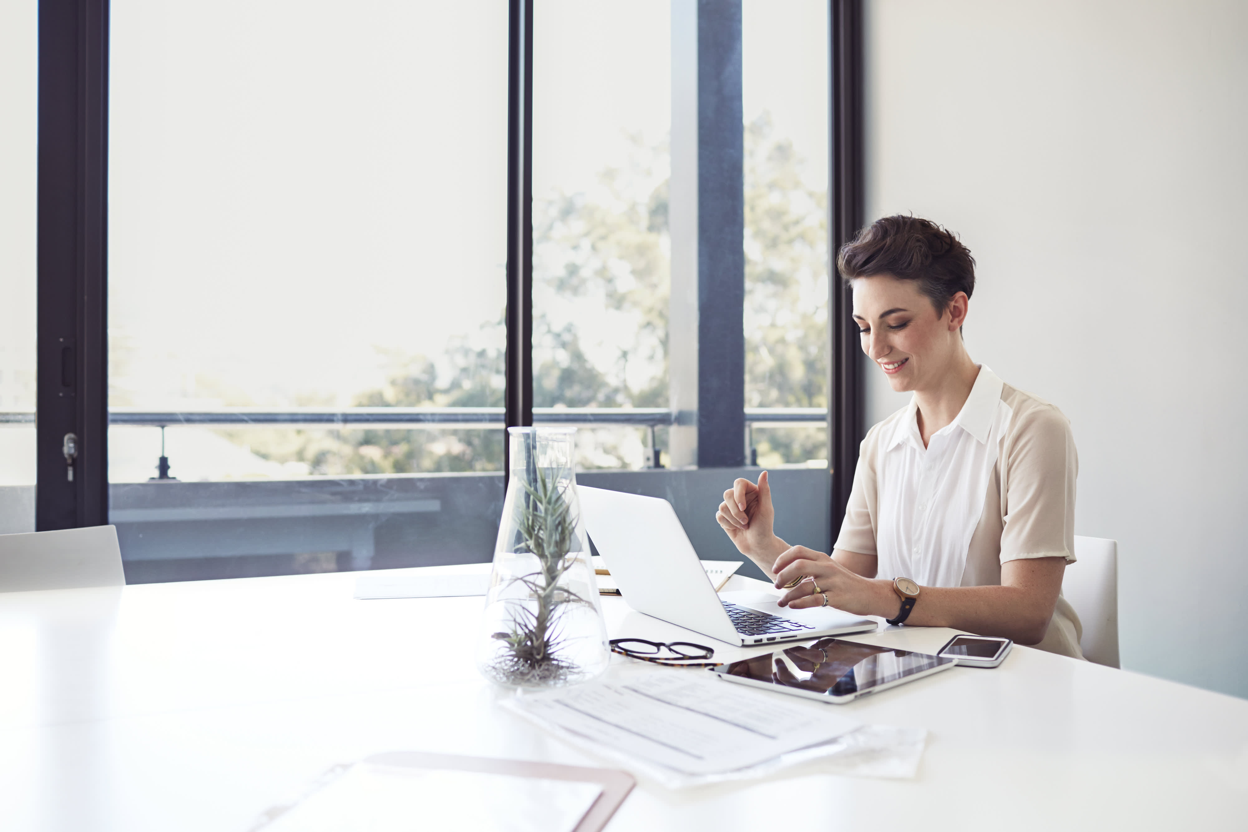 Businesswoman typing on laptop in meetingroom