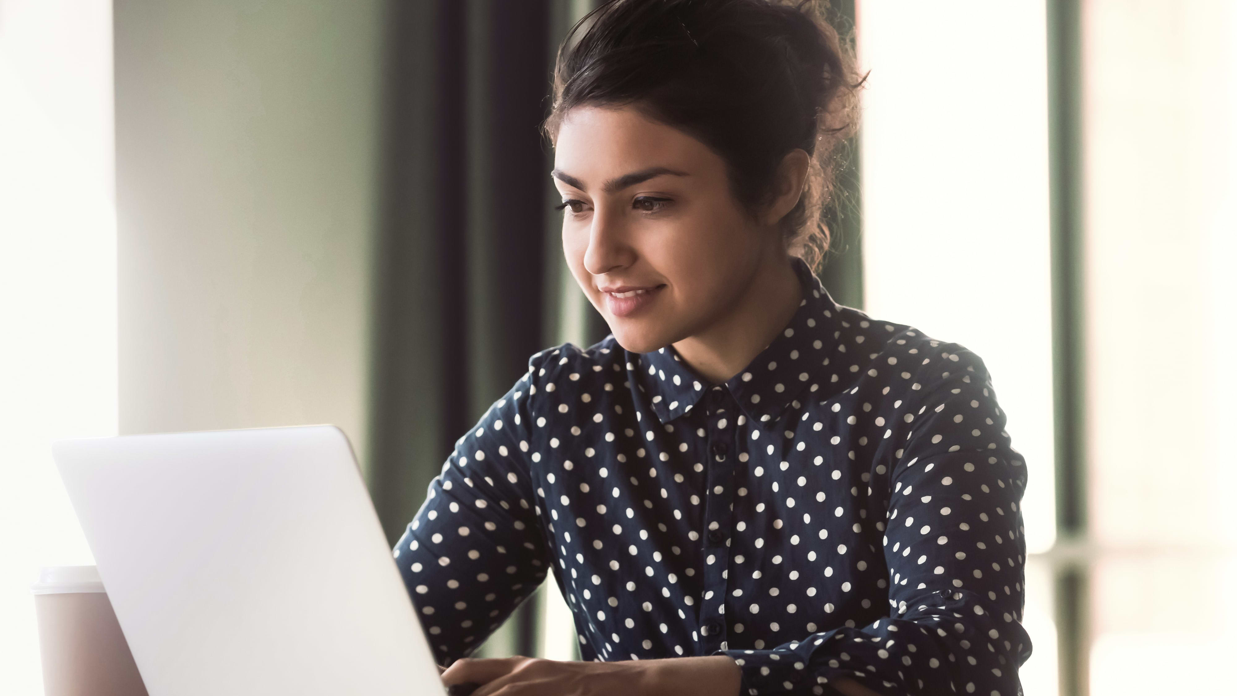 A young Indian woman preparing her APS application on her laptop
